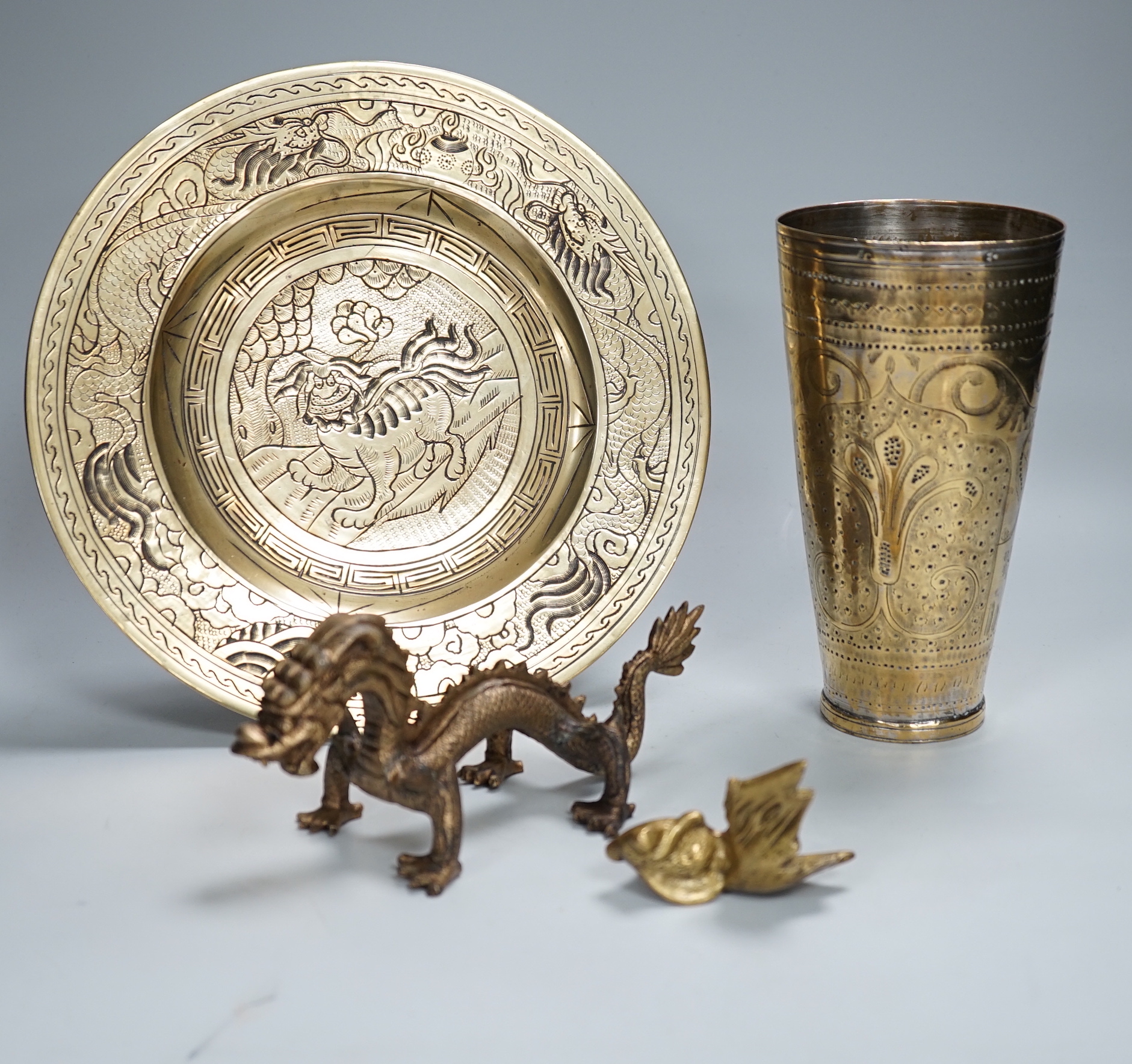 A Chinese engraved brass plate, large engraved beaker, koi fish and a dragon, the largest 24cm in diameter